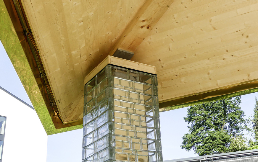 Die hinter den Glasbausteinen positionierte Stahlstütze wurde mit aufgeklebten Siegeln bekleidet