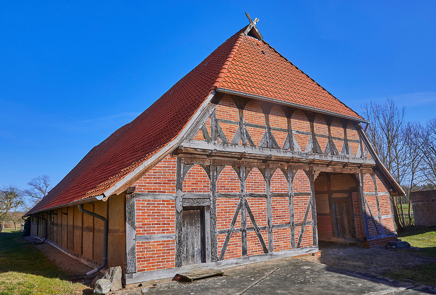Ein Fußwalmdach mit darüberliegendem senkrechtem Giebel, der in manchen Regionen auch Schopf genannt wird