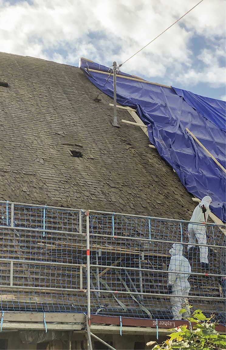 Faserzementplatten und Traglattung sind abgebaut. Rechts ist der neue Dachaufbau und links das alte erhaltenswerte Holzschindeldach zu sehen