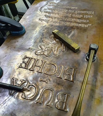 Mit feinem Punzenschlag wird die Inschrift erstellt