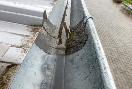 Misslungener Reparaturversuch der gerissenen Lötnaht einer Dachrinne mit Flüssigkunststoff