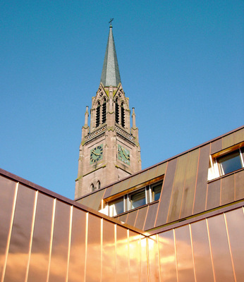 Mit Kupfer bekleidete Mansarden und Fassadenflächen an einem Gemeindezentrum