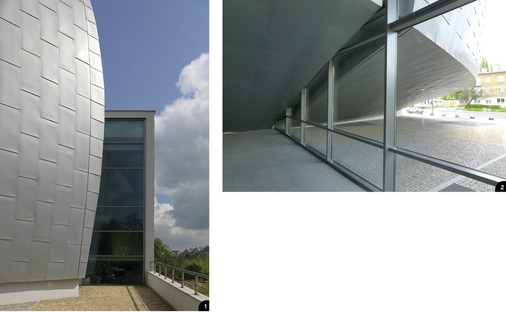 1 Der bislang fertiggestellte erste Bauabschnitt endet mit dem Konzert- und Konferenzsaal2 Der mit Titanzink bekleidete Baukörper schwebt über dem Erdboden und betont mit seinen weichen Rundungen den individuellen Charakter ­seiner Nutzung