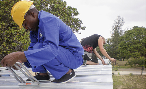 
Berufsschüler aus Hamburg und Mosambik bei der Falzschließung

