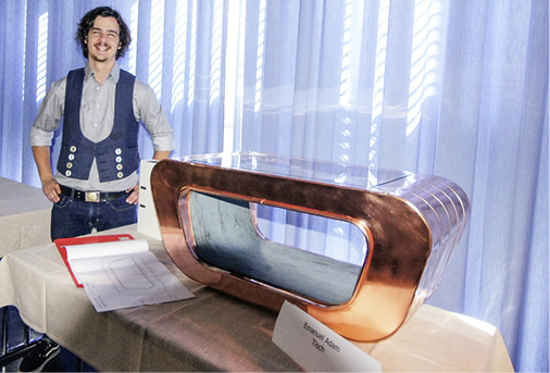 <p>Emanuel Adam präsentiert seinen modernen Wohnzimmertisch aus Kupfer</p> - © HWK Ulm für BAUMETALL