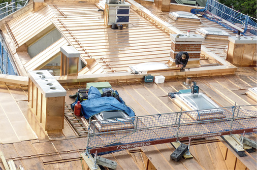 



Endspurt: Letzte Handgriffe am Dachfirst und an der Eindeckung: Die Bekleidung zweier Schornsteine und der Absturzschutz stehen noch auf der Liste
