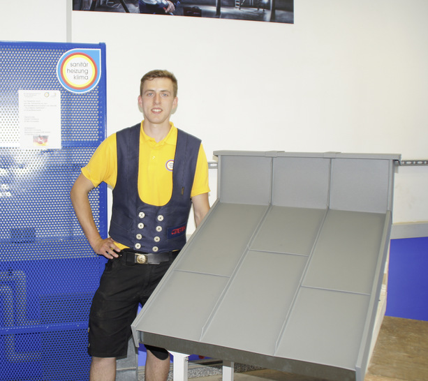Sieger Jonas Carstens neben „seinem“ aluminiumbekleideten Dachmodell - © Bild: SHK Bundesleistungszentrum
