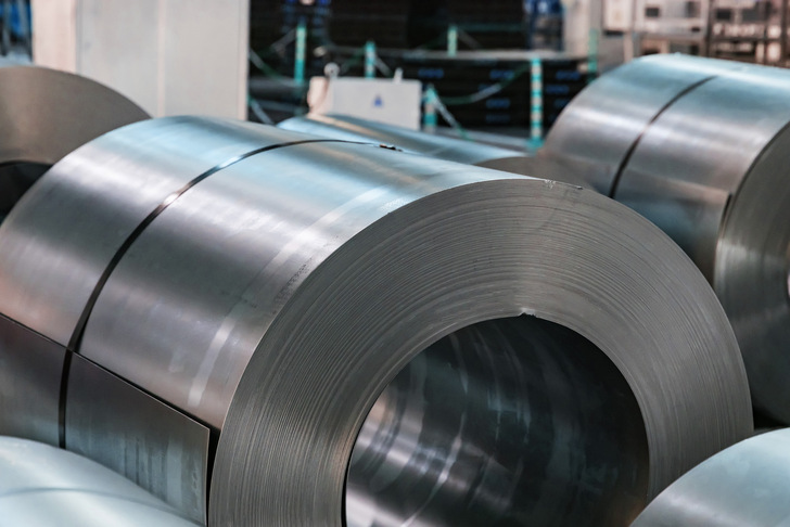 Warehouse with rolls of sheet steel in industrial plant. Hardware manufacturing